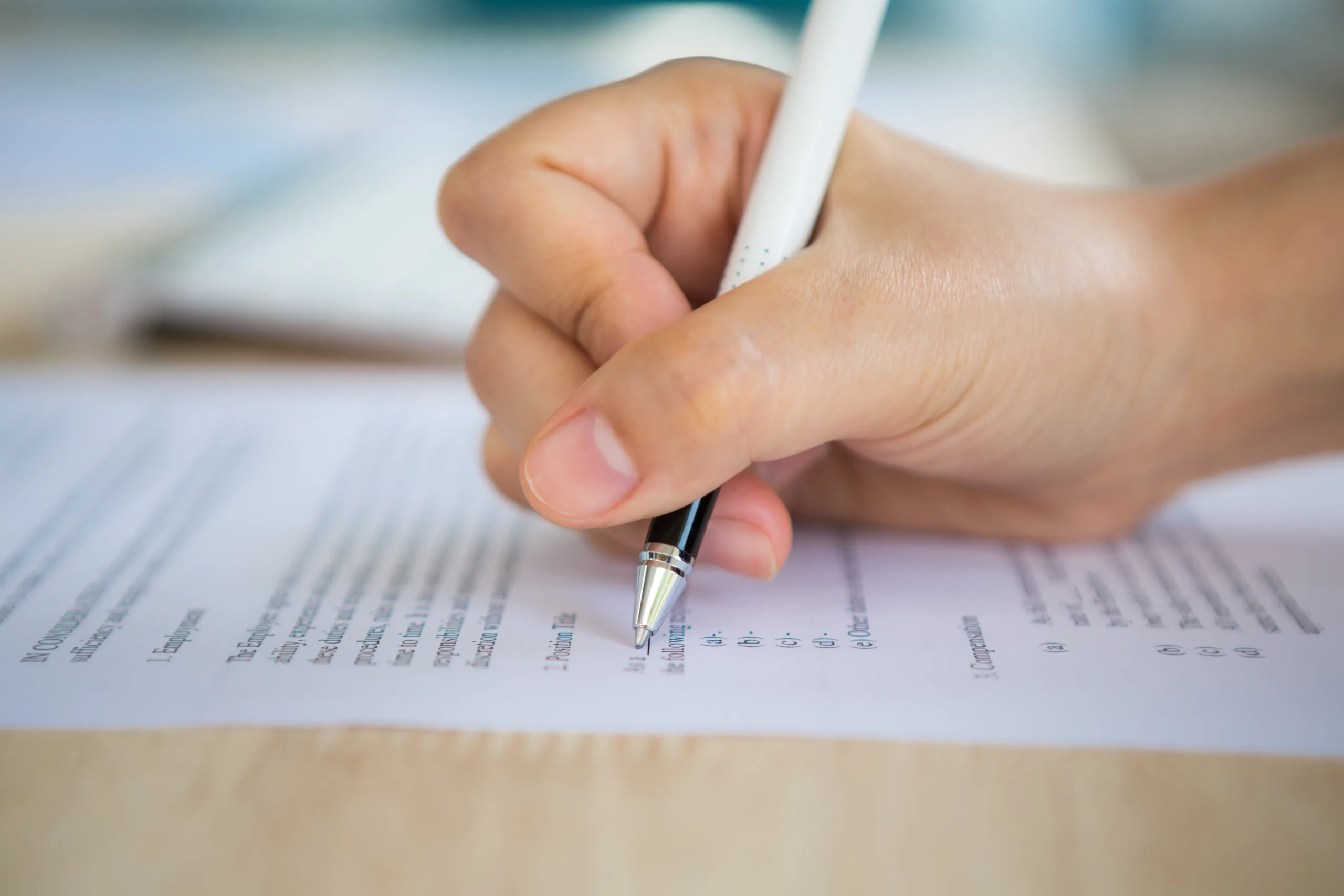 Close up of hand completing an employment application form