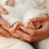 Parents with daughter. Family in a park. Newborn girl.