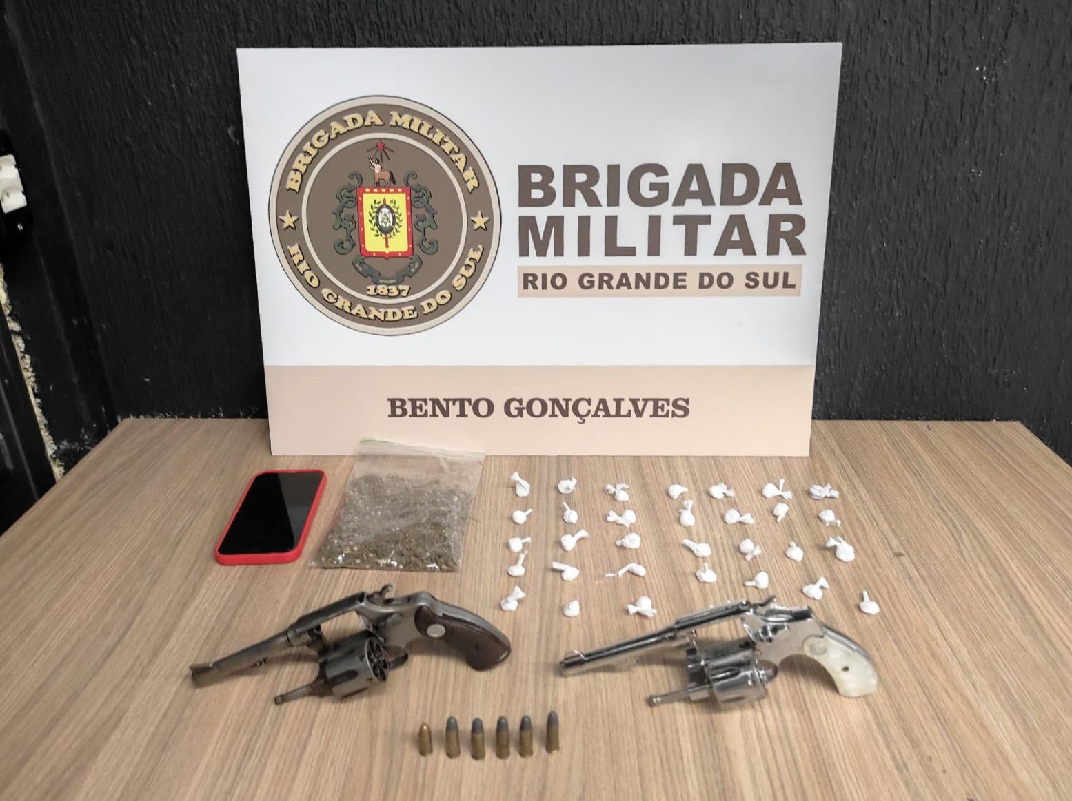 Os policiais localizaram com a dupla dois revólveres calibre .32, seis munições, uma porção de maconha, um celular e 33 porções de cocaína.