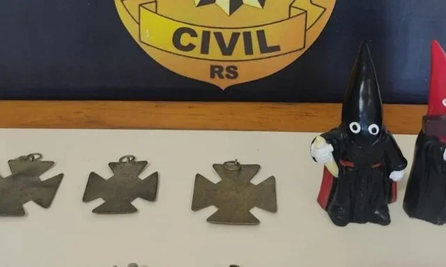 Suásticas e bonecos da Ku Klux Klan foram apreendidos na casa do suspeito | Foto: Polícia Civil / Divulgação