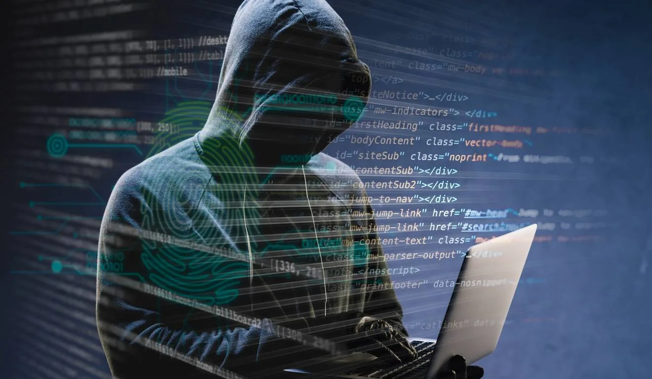 Hacker anônimo em frente ao código de computador. Hacker anônimo em frente ao código de computador.