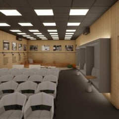Auditório moderno com fileiras de cadeiras cinzas, detalhes em madeira e iluminação elegante.